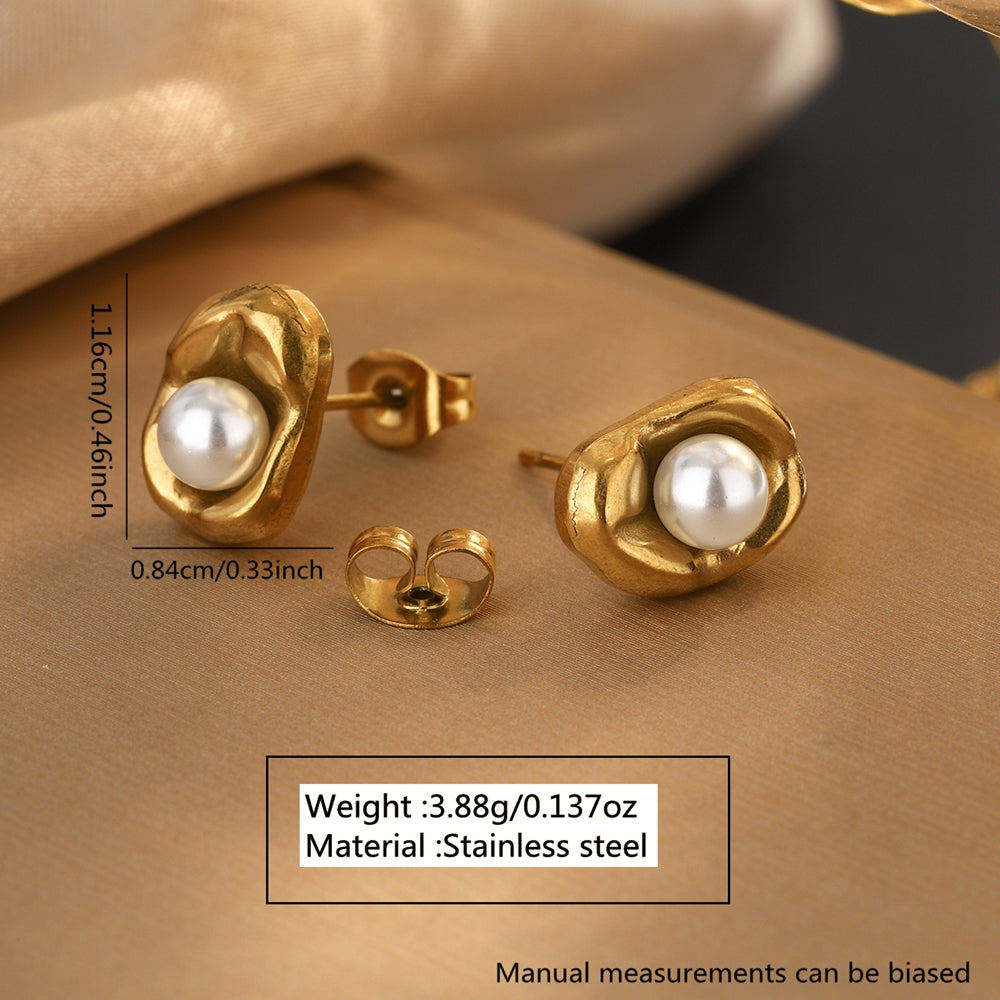 Gold earrings with pearls on a beige surface, showing measurements and material details.