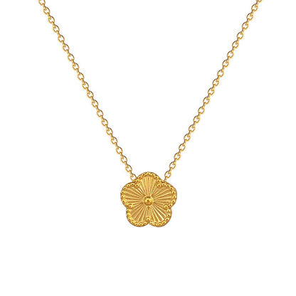 Gold necklace with a floral pendant on a white background