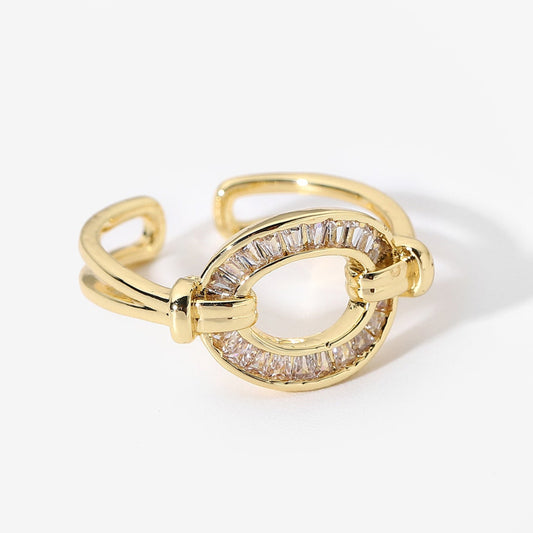 Gold ring with baguette cut stones on a white background