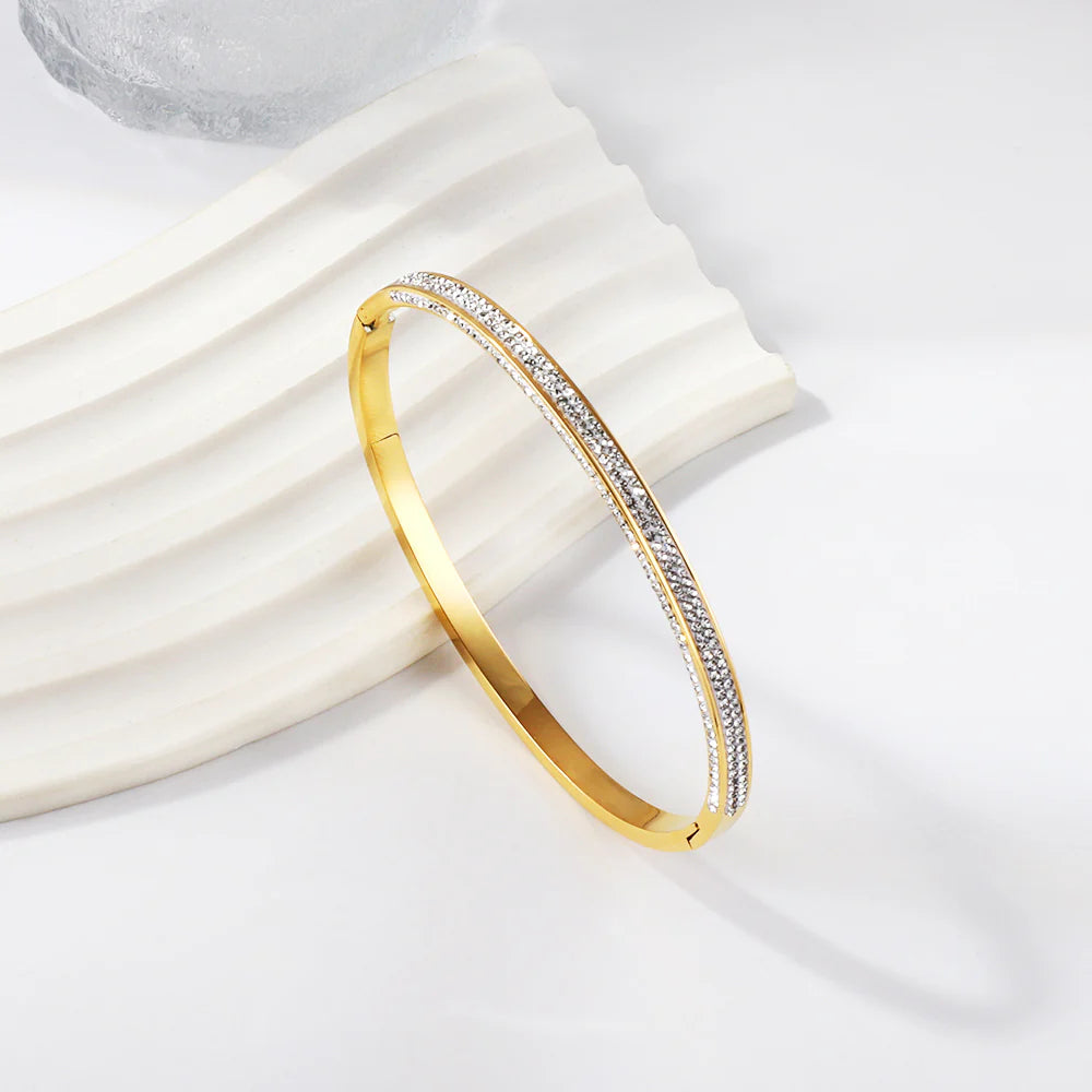 Gold bracelet with diamonds on a white background